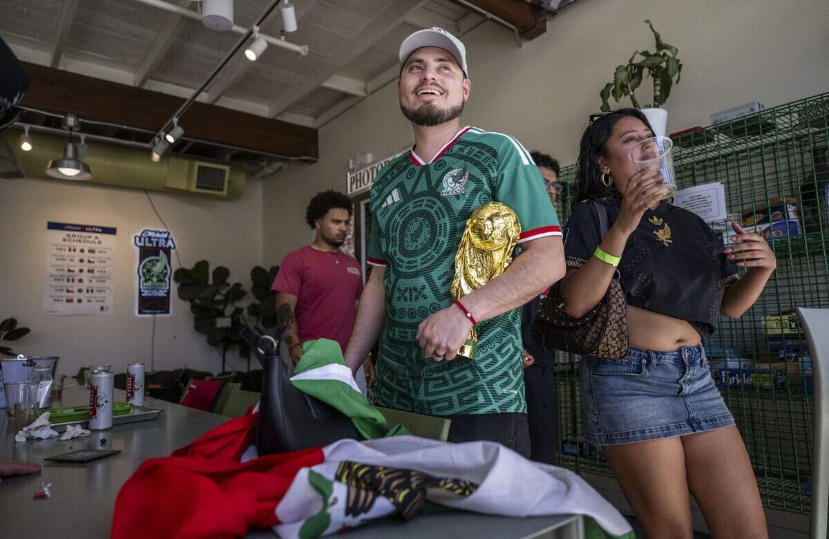Mauricio Guerrero Lopez, of Sacramento, holds a replica of the FIFA World Cup Trophy after a watch party at Garden at the Line in Sacramento on Thursday, June 11, 2026. Mexico won 2-0 to South Africa.