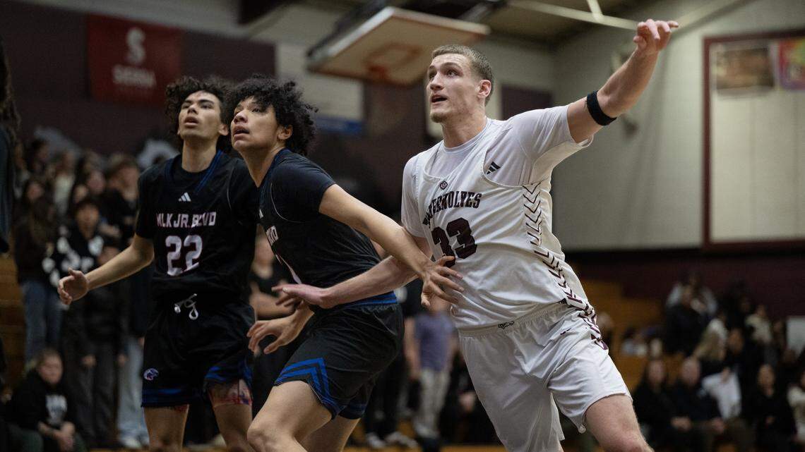 The Woodcreek Timberwolves' Max VanLaningham (33) battles the Christian Brothers Falcons' Jaden DeJesus-Eves (11) for position under the basket on Thursday in Roseville.