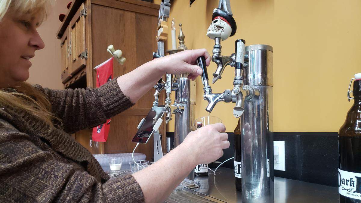DarkHeart co-founder Cynthia Lee pours a beer at the quirky Sacramento Brewery.