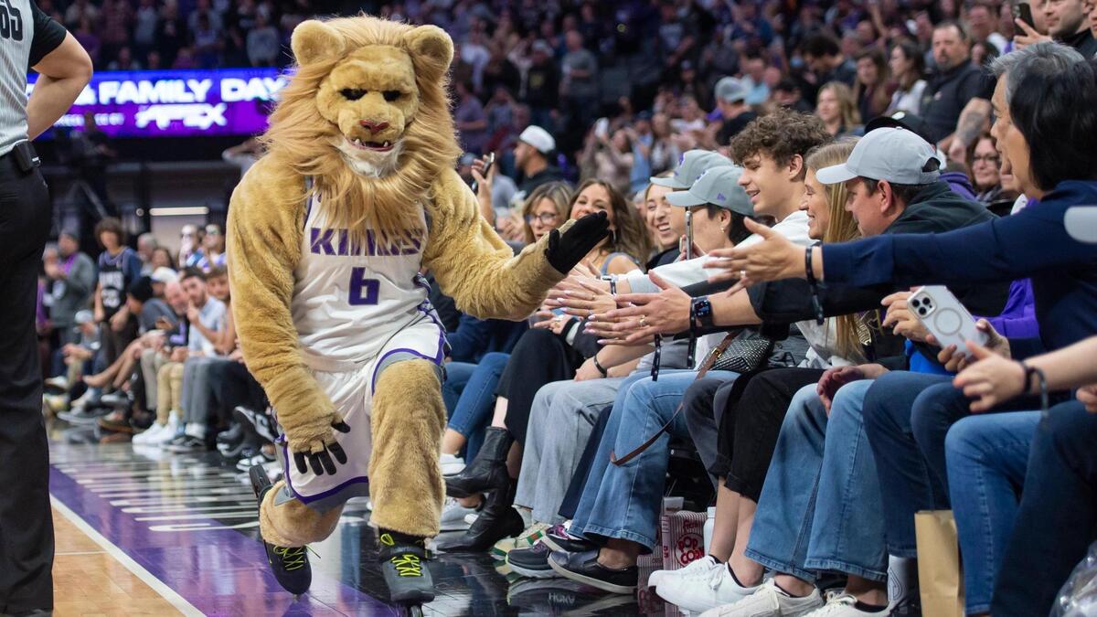 Slamson the Lion high-fives fans on the sidelines as he rollerblades past during a timeout in the second half of the NBA basketball game Sunday, April 2, 2023, at Golden 1 Center. The Spurs won 142-134 in overtime.