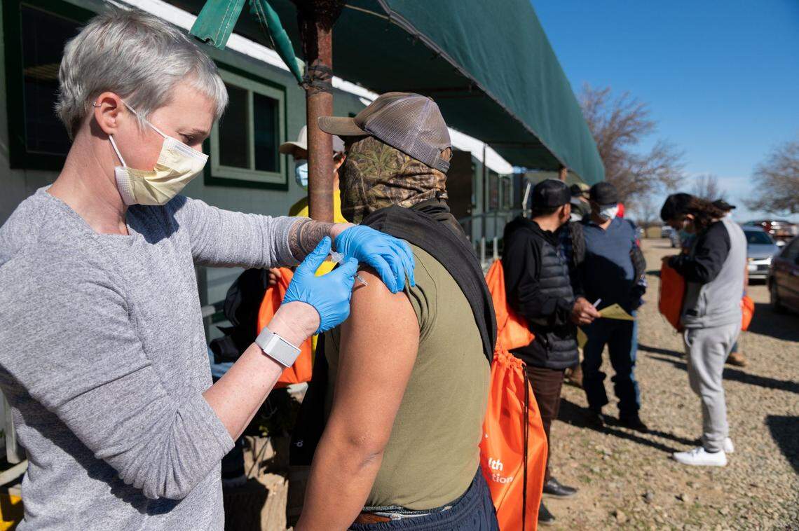 Yolo County EMS Administrator Kristin Weivoda gives the COVID-19 vaccine to farmworker Rigo Martinez, 37, from Dunnigan on Wednesday, Feb. 17, 2021 at Durst Organic Growers near Esparto in a pilot clinic that the county hopes will expand to up to four farms a week. “The big thing is that we want to make sure it says equitable” by bringing the vaccine to a workplace were people might not otherwise have access to it, Weivoda said.