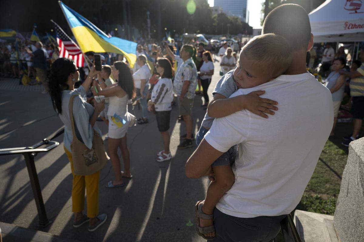 Viktor Barmin, right, holds his son Yan Barmin during a Ukrainian Independence Day celebration at the California Capitol in Sacramento on Sunday.
