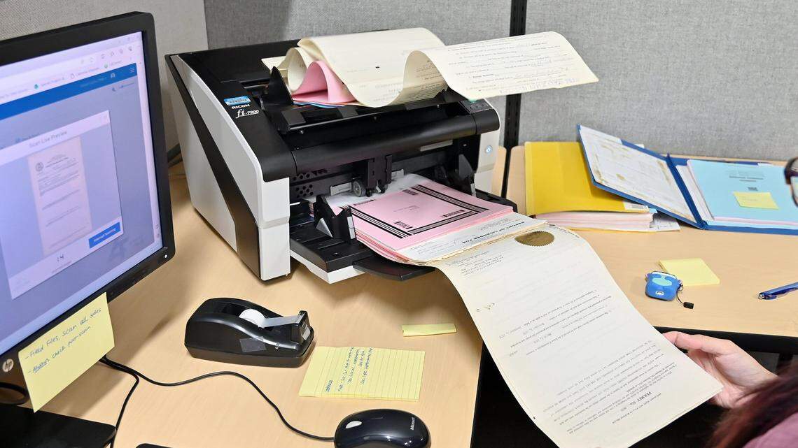 A student assistant scans a file into the system at CalEPA Headquarters Building in downtown Sacramento on Dec. 20. The California Environmental Protection Agency in a Jan. 12 email announced its intent to bring workers back to the office at least two days a week by “early this spring.”