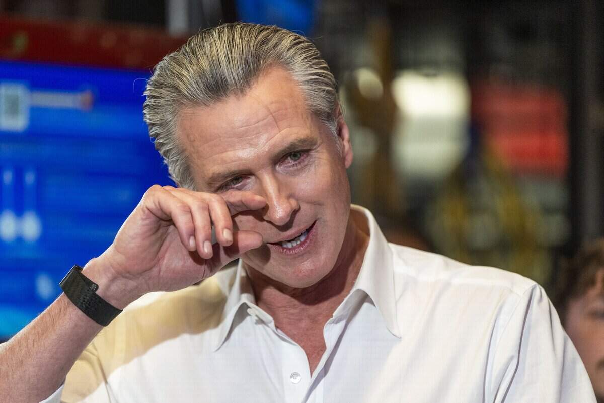 An emotional Gov. Gavin Newsom is overcome with emotion after listening to members of the California Service Corps tell stories during his visit to Shop Class, a nonprofit learning center in Sacramento's Oak Park neighborhood on Wednesday. He was helping to launch a new recruitment drive for the volunteer corps.