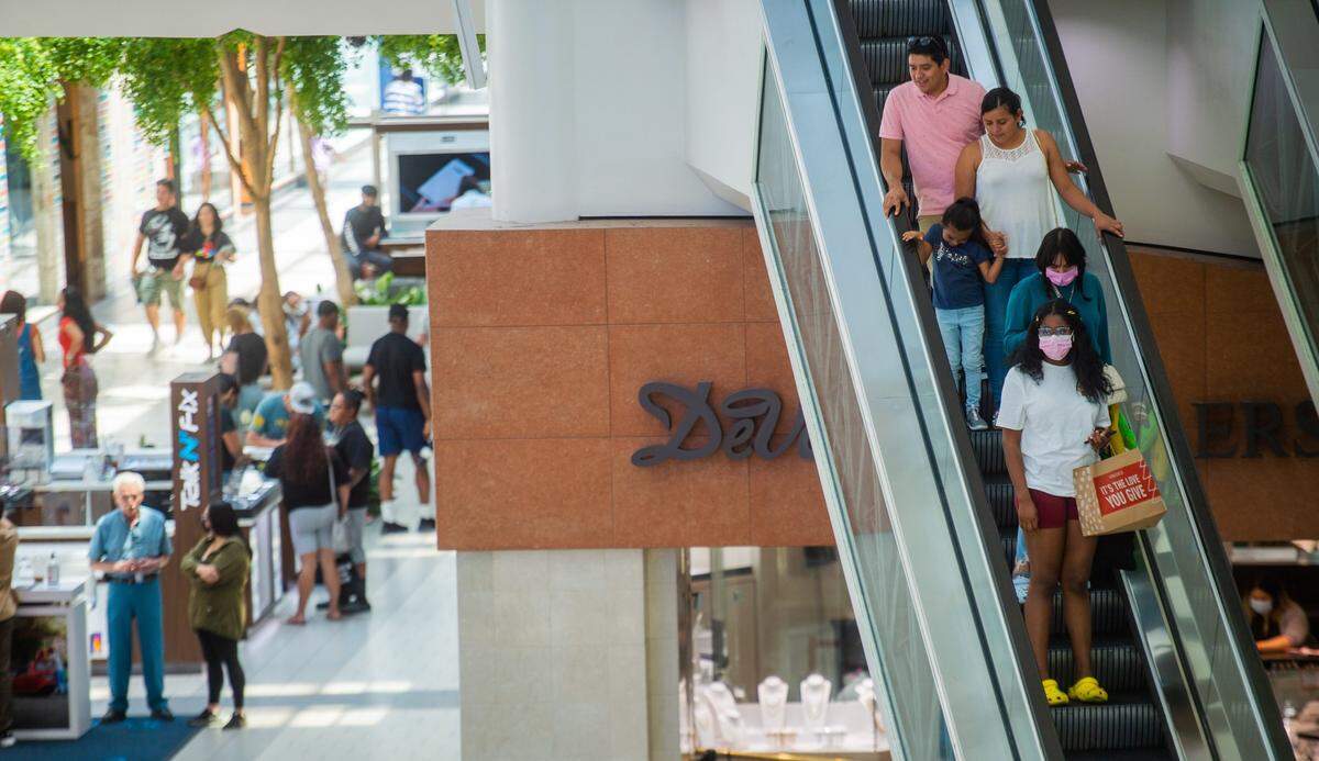 Shoppers descend on an escalator at Arden Fair mall in Sacramento on Thursday, July 15, 2021.