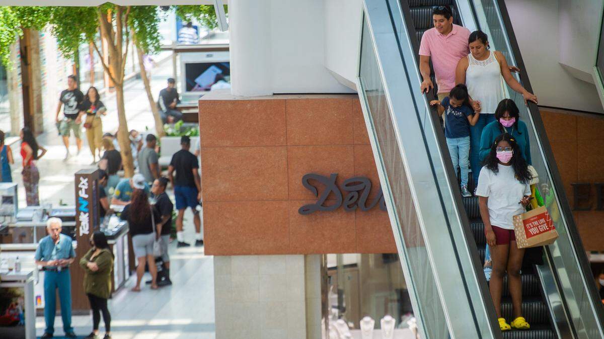 Shoppers descend on an escalator at Arden Fair mall in Sacramento on Thursday, July 15, 2021.