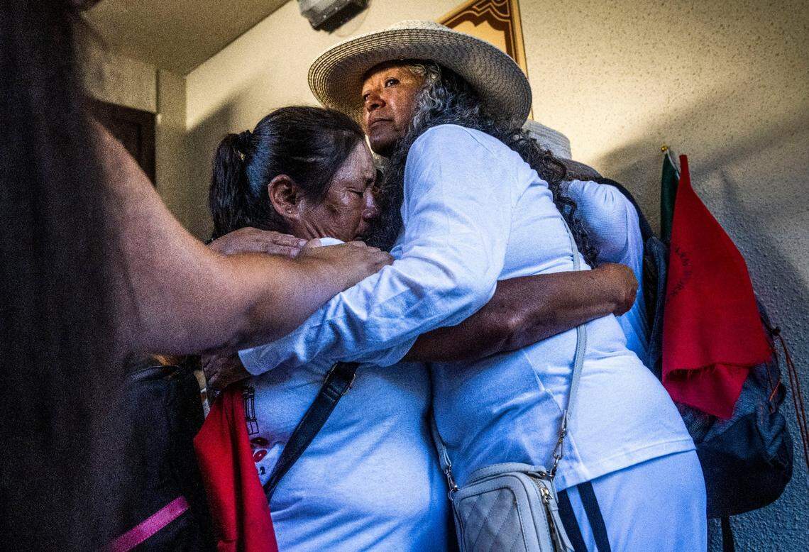 United Farm Workers president Teresa Romero embraces Teresa Maldonado, of Lamont, on Friday at Our Lady of Guadalupe church in Sacramento after receiving the news that Gov. Gavin Newsom would not sign Assembly Bill 2183, which would allow farmworkers vote at home ballot to unionize because of concerns about the integrity of the mail-in ballot process.