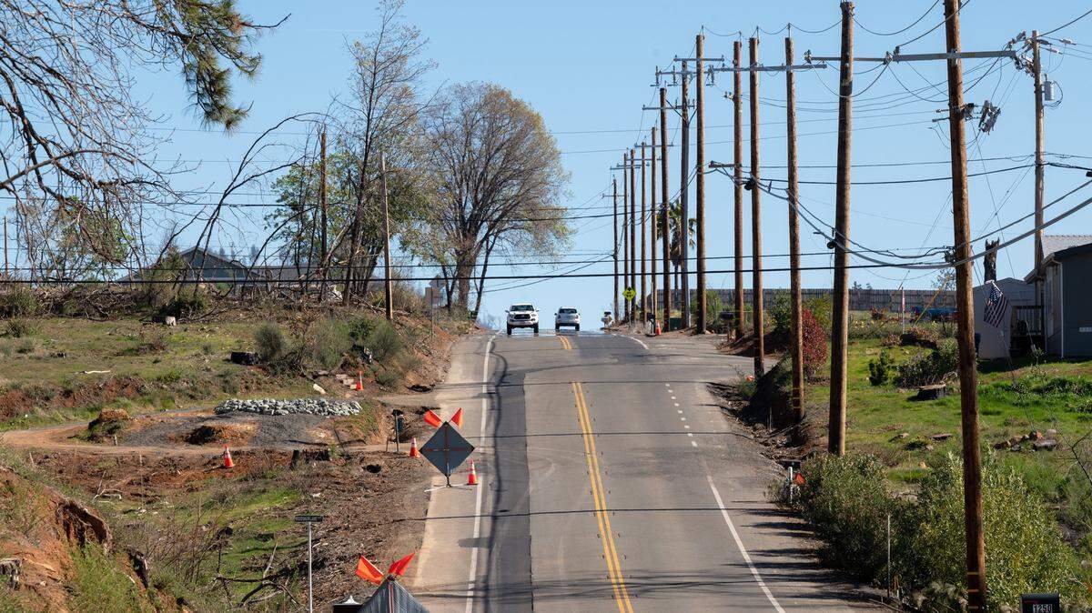 Newly install underground utilities are marked with new asphalt after PG&E crews installed the utilities along Pearson Road on Thursday, Feb. 17, 2022 in Paradise.