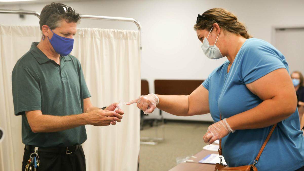 Employees of Twin Rivers Unified School District work on testing for COVID-19 on Wednesday, Aug. 2, 2020. The district purchased thousands of testing swabs in anticipation of in-person learning returning later this year. It is one of the few districts in the state preparing to test staff and students.