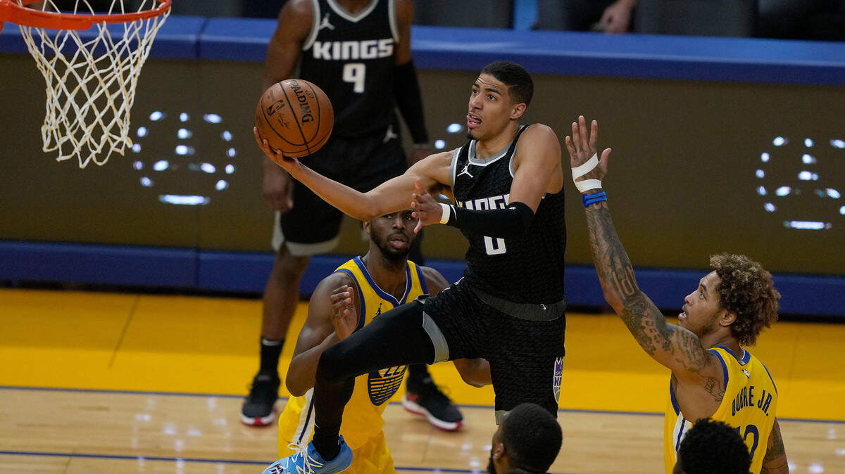 Sacramento Kings guard Tyrese Haliburton (0) drives to the basket against Golden State Warriors guard Kelly Oubre Jr. (12) during the second half of an NBA basketball game on Sunday, April 25, 2021, in San Francisco. (AP Photo/Tony Avelar)