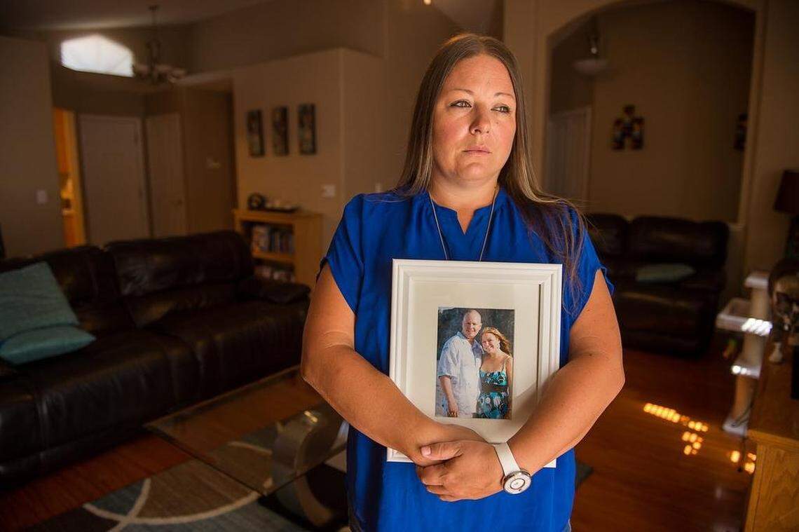 Allison Irwin holds a portrait of herself and husband Chad at home on Thursday, August 16, 2018 in Citrus Heights, Calif. Chad Irwinwas shot to death in front of their home by Sacramento County Sheriff’s deputies.