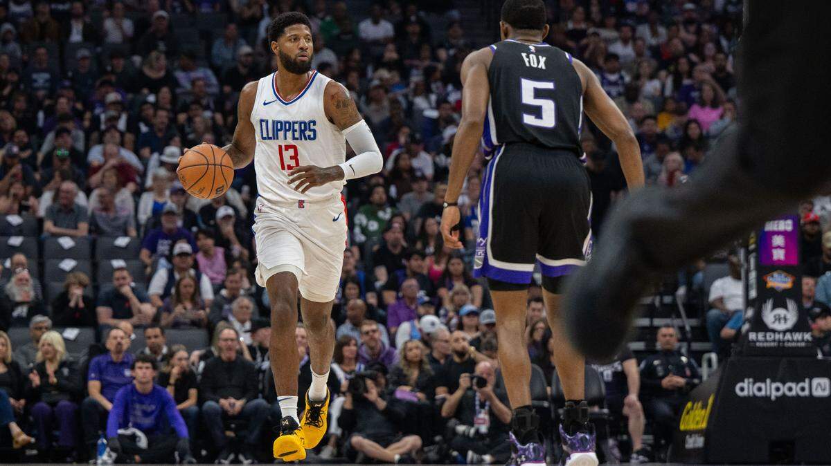 Former LA Clippers forward Paul George (13) drives to the basket against Sacramento Kings guard De’Aaron Fox (5) during an NBA game on Tuesday, April 2, 2024 at Golden 1 Center.