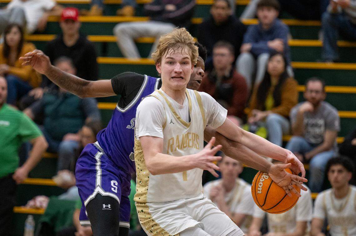 The Sacramento Dragons’ Devion Watts slaps the ball away from the Rio Americano Raiders’ Ian Engh in the second half on Wednesday, Feb. 19, 2025 in Sacramento. Ingh scored 33 points for the Raiders in Wednesday night’s loss to the Whitney Wildcats in Rocklin, in the opening round of the CIF Sac-Joaquin Section Division II playoffs.