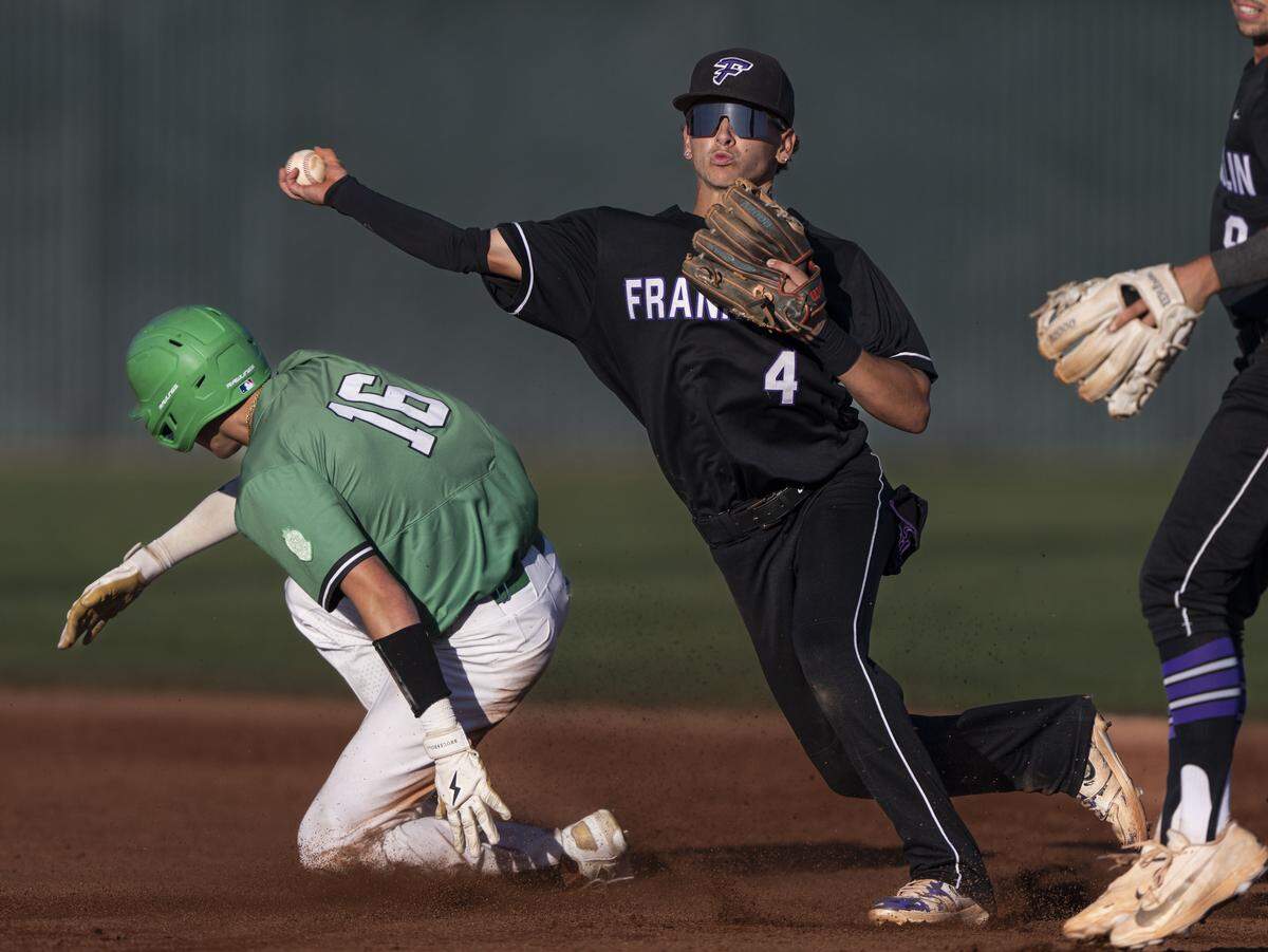 Franklin Wildcats infielder Easton Fernald attempts to make a double play after tagging St. Mary's Rams outfielder Gino Lovotti out during the CIF Sac-Joaquin Section Division I baseball championship Friday at Sacramento City College.