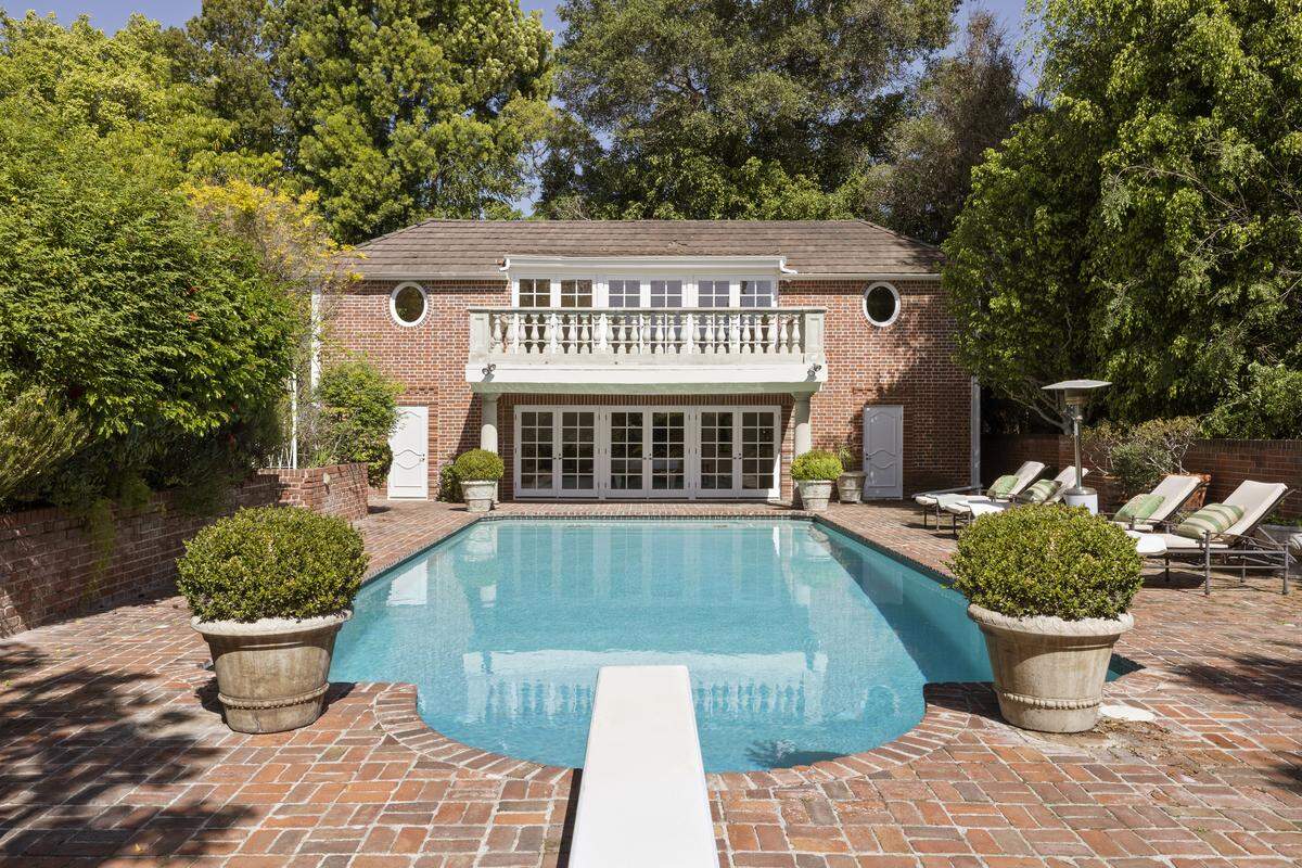 A large swimming pool still features an original-style diving board.