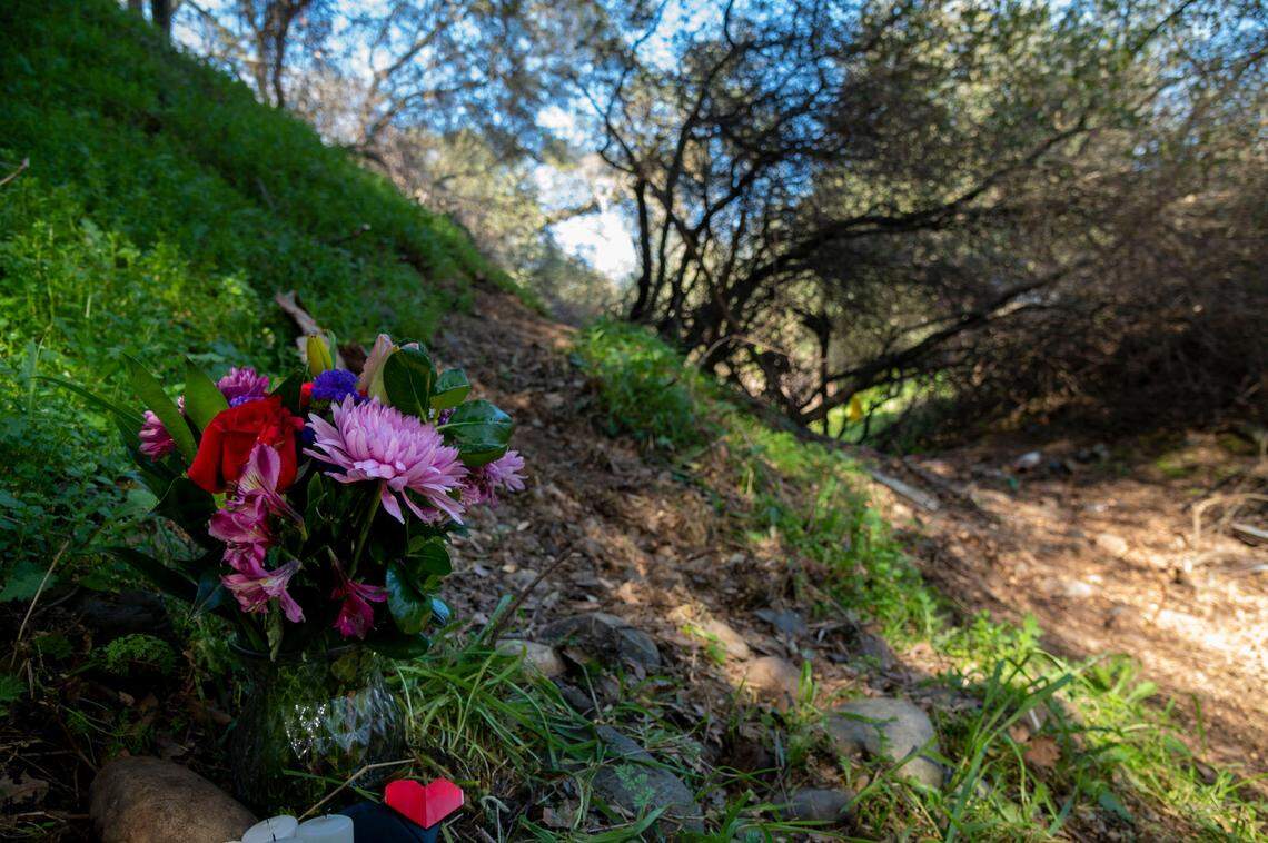 A bouquet of flowers is left at the campsite of Mikilo Rawls in February where the body of Emma Roark, 20, was found on the American River Parkway near Rancho Cordova. Rawls, 37, was arrested after DNA tied him to the crime and now faces charges of murder with three special circumstances that could lead to prosecutors seeking the death penalty, according to court documents.