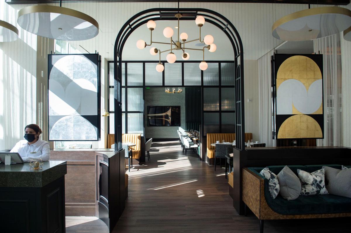 A hostess stands ready to greet customers at the new Hyatt Centric’s restaurant called The 7th Street Standard on Thursday, Nov. 11, 2021, at the former site of the historic Clayton and Marshall hotel.