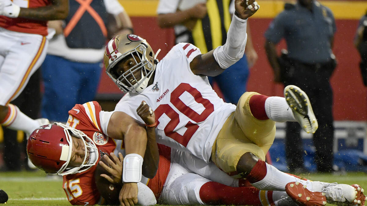 Kansas City Chiefs quarterback Patrick Mahomes (15) dives as he is tackled by San Francisco 49ers cornerback Jimmie Ward (20) during the first half of an NFL preseason football game in Kansas City, Mo., Saturday, Aug. 24, 2019. (AP Photo/Ed Zurga)