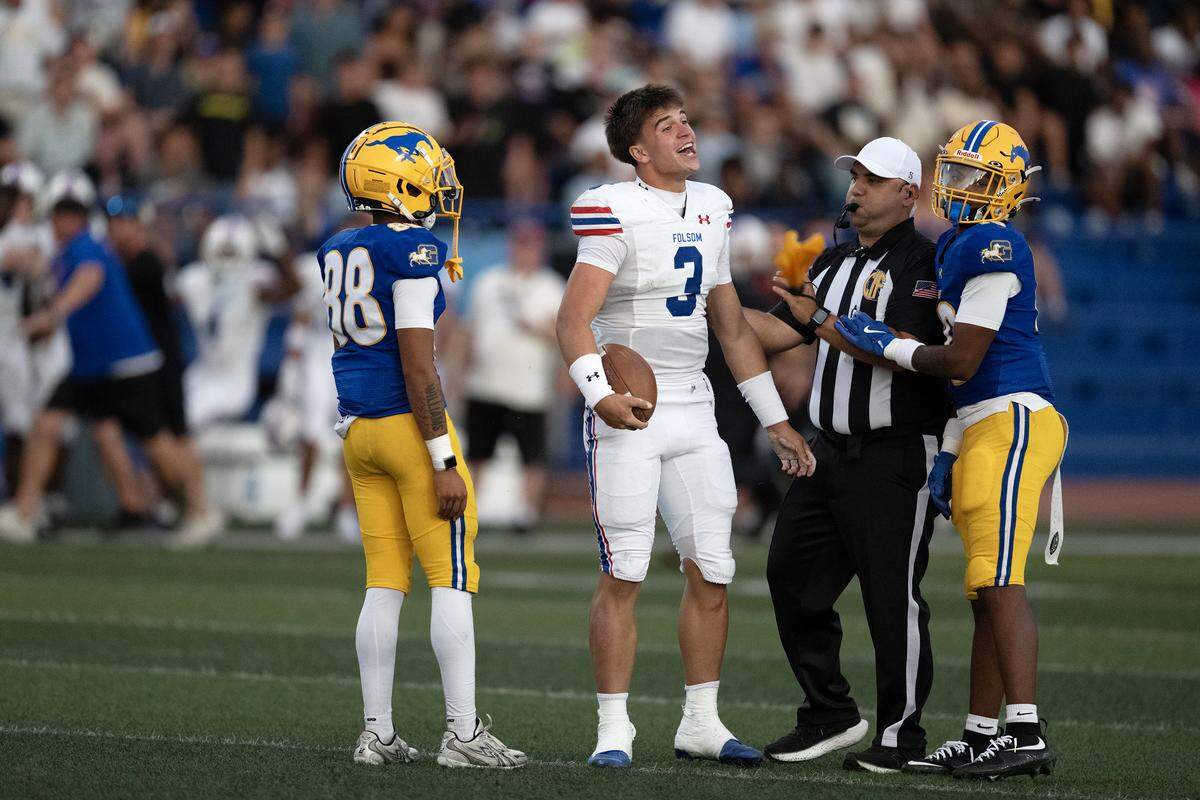 Folsom Bulldogs quarterback Ryder Lyons (3) yells toward the Grant Pacers bench after a play in the first half on Saturday in Del Paso Heights.