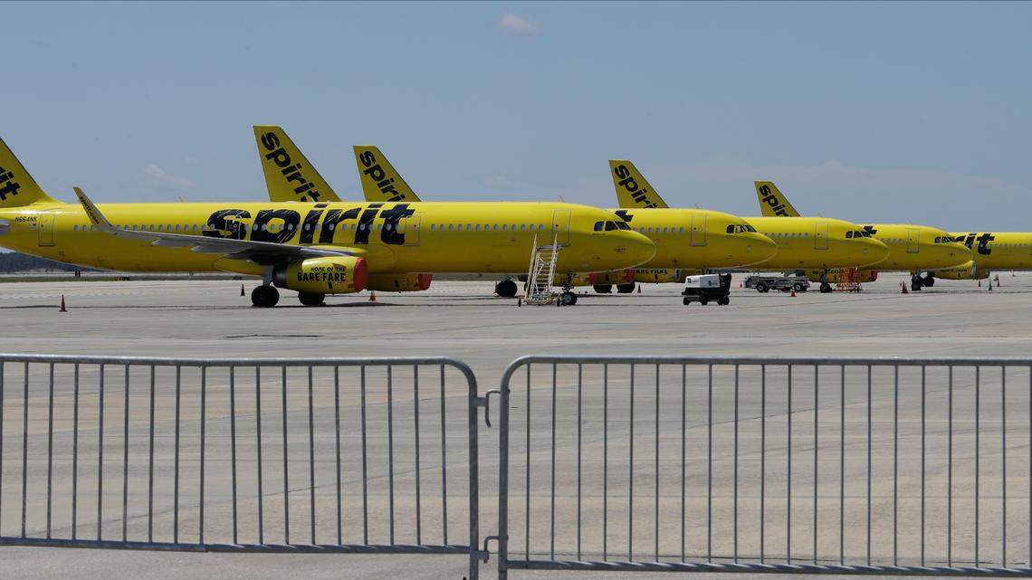 FILE - A line of Spirit Airlines jets sit on the tarmac at the Orlando International Airport Wednesday, May 20, 2020, in Orlando, Fla. Spirit Airlines is warning, Wednesday, July 29, 2020, employees that it could furlough up to 30% of its roughly 9,000 workers in October, when federal payroll-help money runs out. (AP Photo/Chris O’Meara)