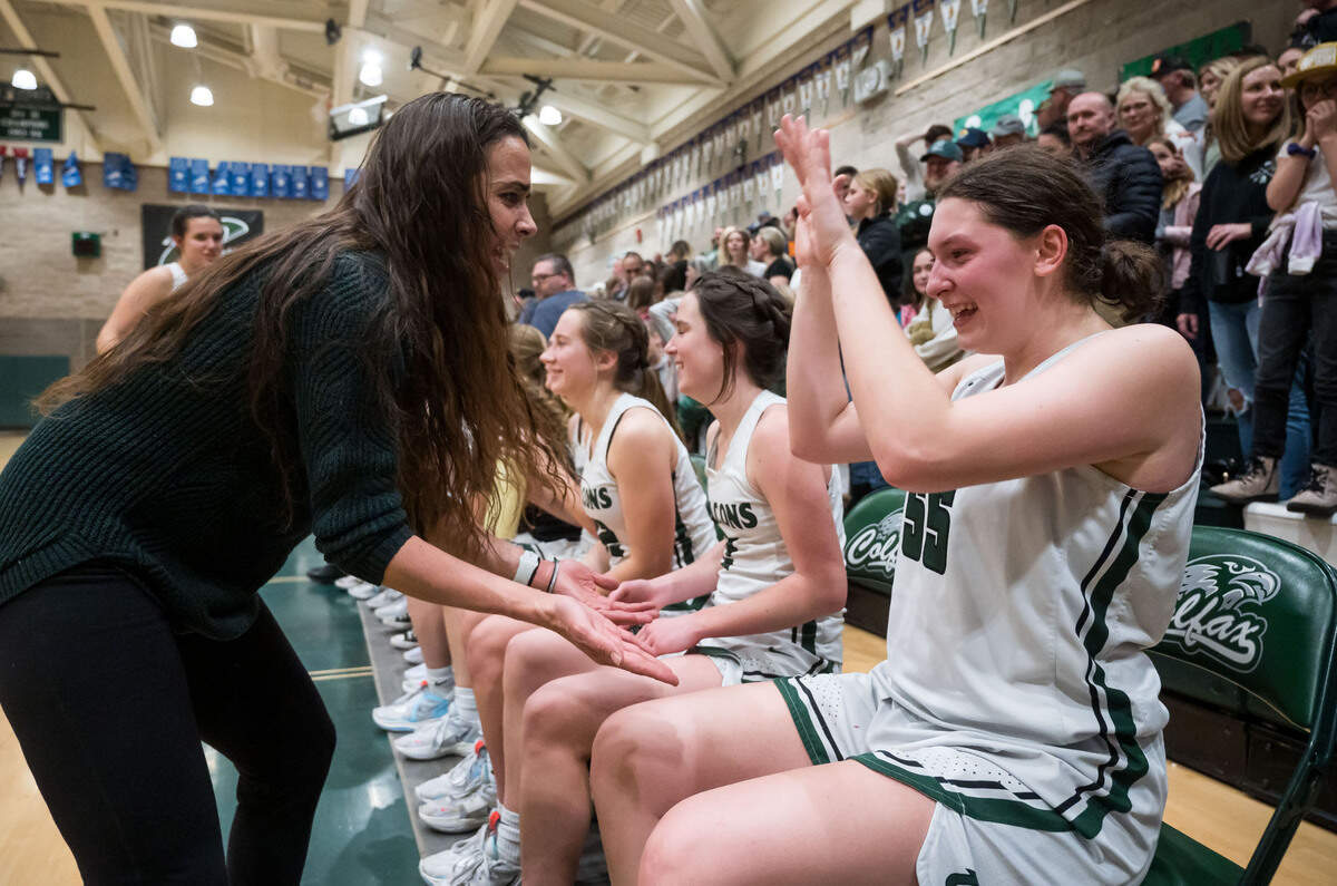 Colfax Falcons head coach Rexanne Simpton, left, congratulates center Juliette James and her teammates after their 53-52 win over the Caruthers Blue Raiders after the 2023 CIF Northern California Division III girls basketball championship game.