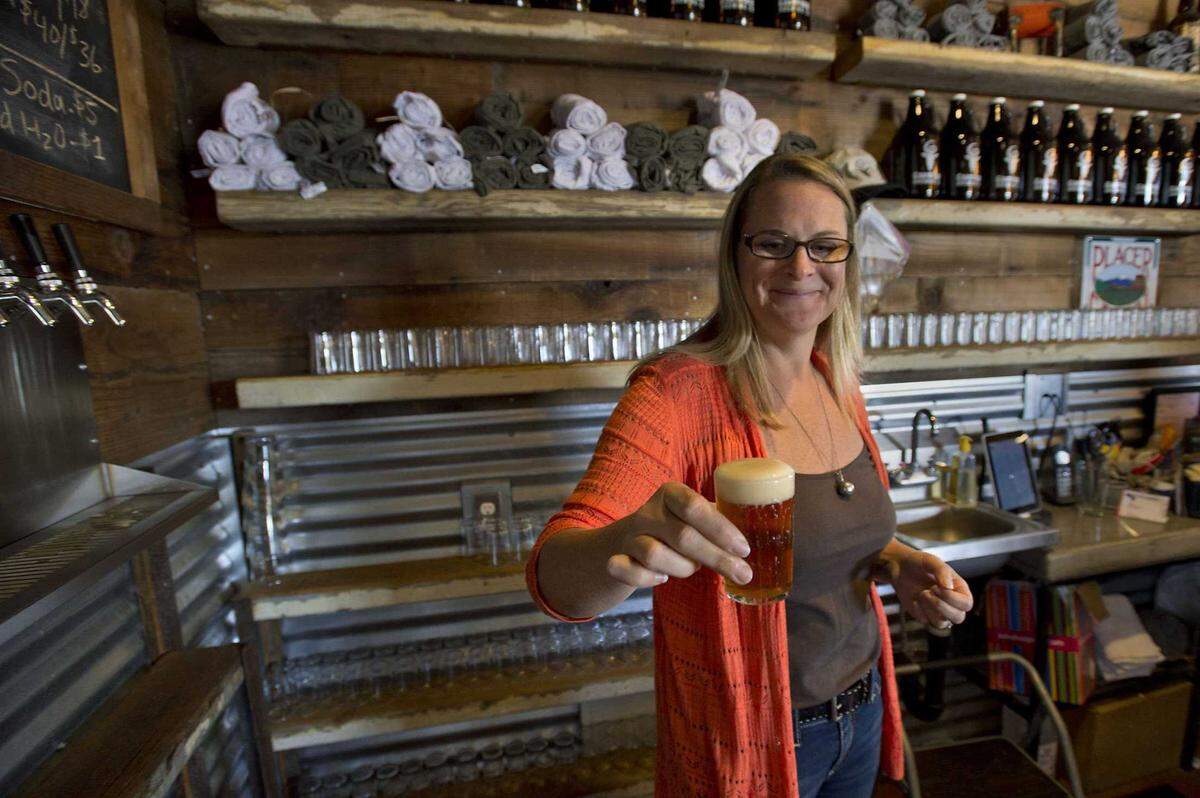 Brewery owner Cathy Johnson with a sample of beer in the tasting room at the Goathouse Brewery in Lincoln in 2014. The brewery/farm, owned by Michael and Cathy Johnson. They have a brewery, tasting room, hop farm, bee hives, goats, chickens and fruits and vegetables on 11 acres in Lincoln.