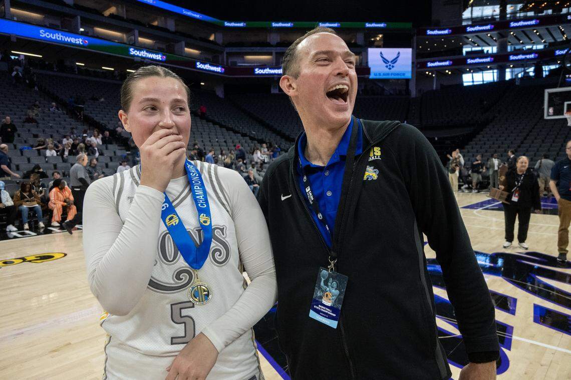 Faith Christian Lions coach Geoff Harris embraces his daughter Lauren Harris following the victory over the Palisades Dolphins in the CIF State Division IV girls basketball championship Saturday at Golden 1 Center.