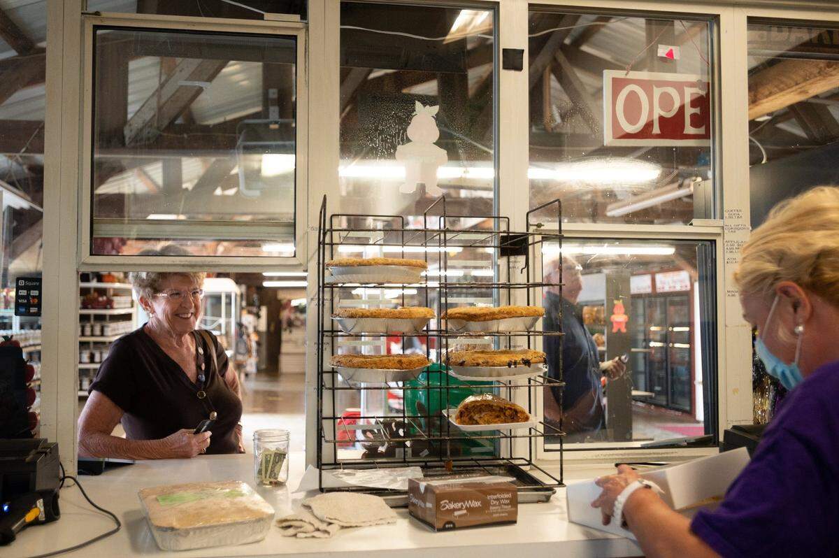 Nick and Donna Roenick of Placerville buy pies at Abel’s Apple Acres, a member of the Apple Hill Growers Association in September, while the Caldor Fire burned in El Dorado County.