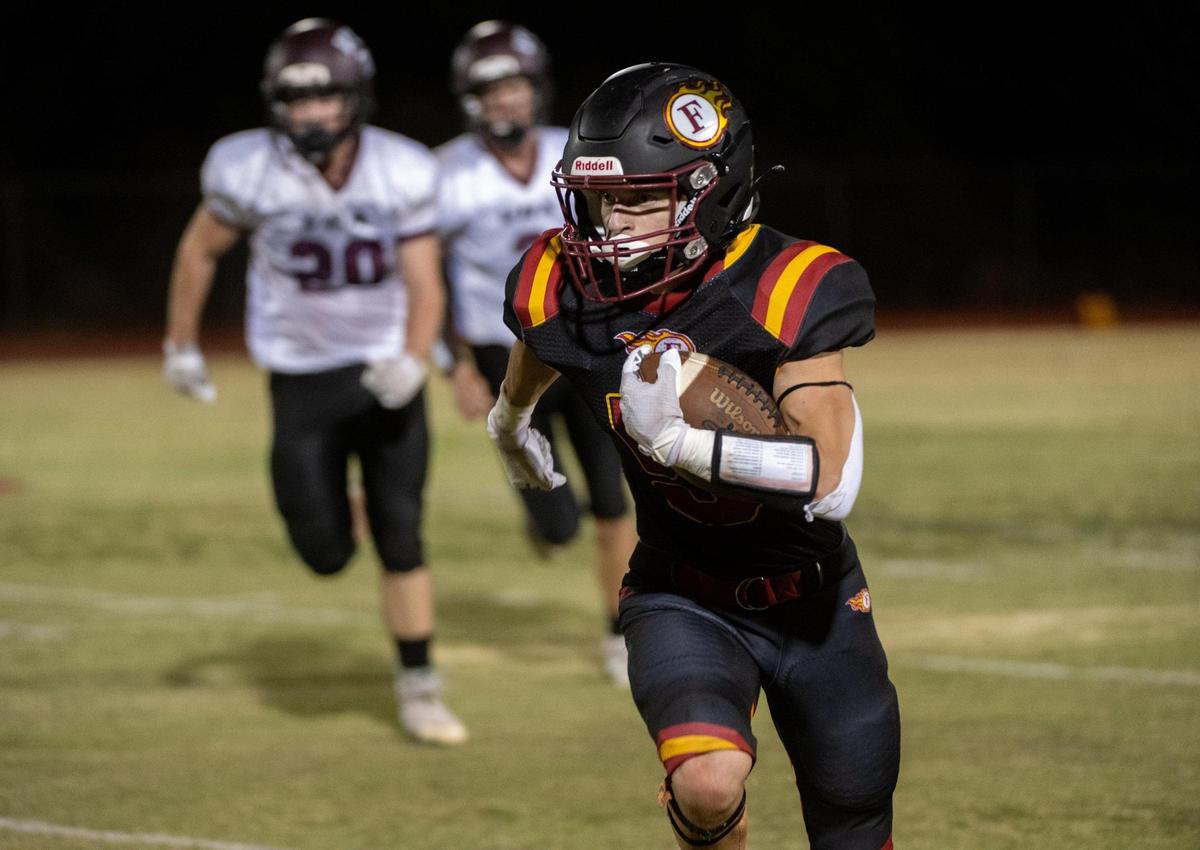 Matthew Nance (5) runs for yardage against Valley Christian Lions at Foresthill High School on Friday during the Wildfires first home game since Sept. 2 due to the Mosquito Fire.