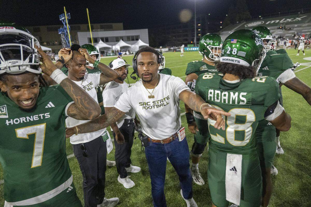 Sacramento State Hornets head coach Brennan Marion relieves quarterback Cardell Williams (7) on the final play of their 49-28 victory against the Mercyhurst Lakers on Saturday at Hornet Stadium in Sacramento.