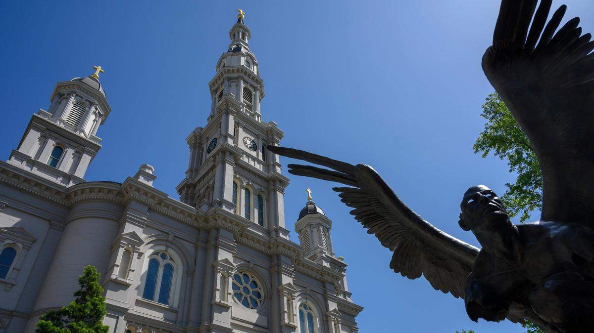 The Cathedral of the Blessed Sacrament in Sacramento is framed behind the bronze sculpture El Tiempo by artist Jorge Marin in 2019.