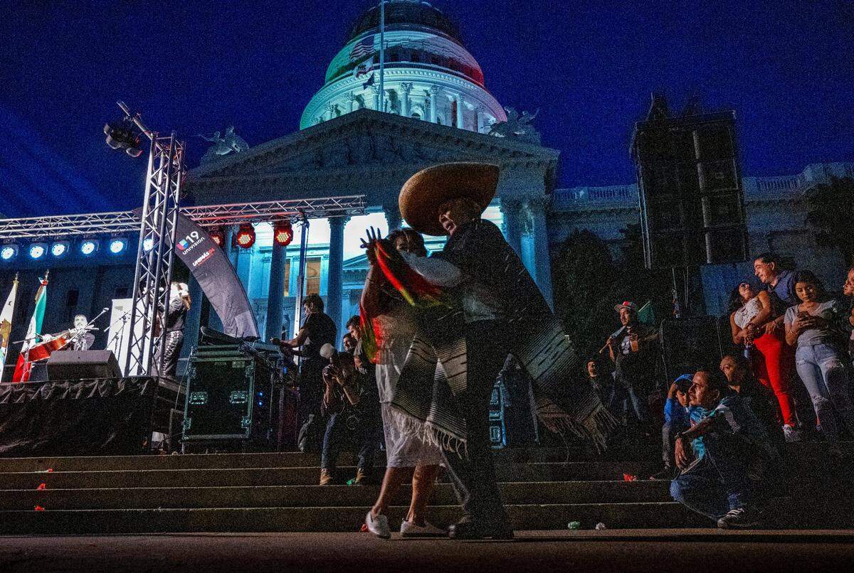 A couple dances as Mariachi Bonitas de Dinorah perform at a celebration of the Mexican Day of Independence on the west steps of the state Capitol on Thursday, Sept. 15, 2022.