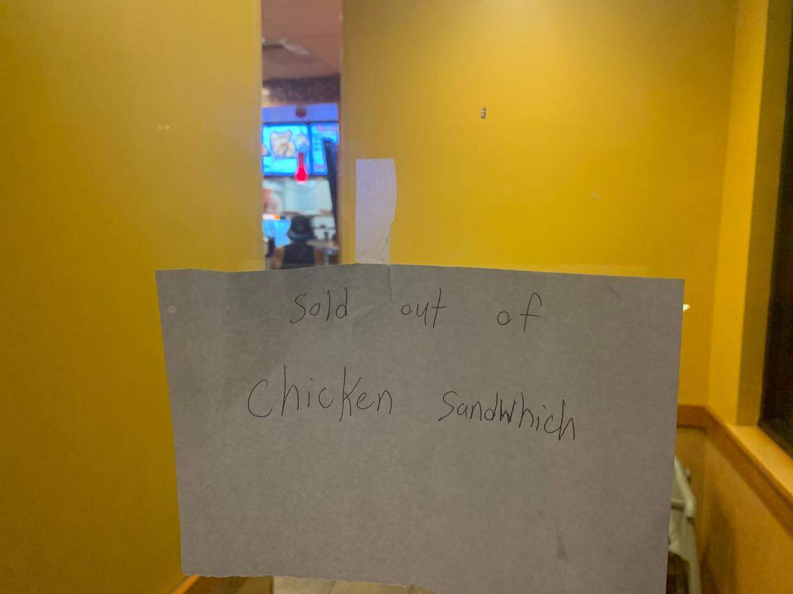 A handwritten note posted on the window of the Arden Arcade Popeyes store