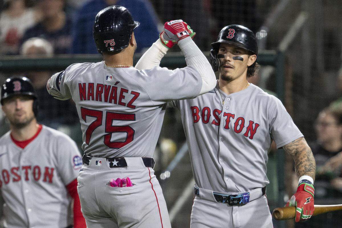 Boston Red Sox catcher Carlos Narváez (75) and Boston Red Sox outfielder Jarren Duran (16) celebrate after scoring during a game between the Athletics and the Red Sox at Sutter Health Park in West Sacramento on Monday, Sept. 8, 2025.