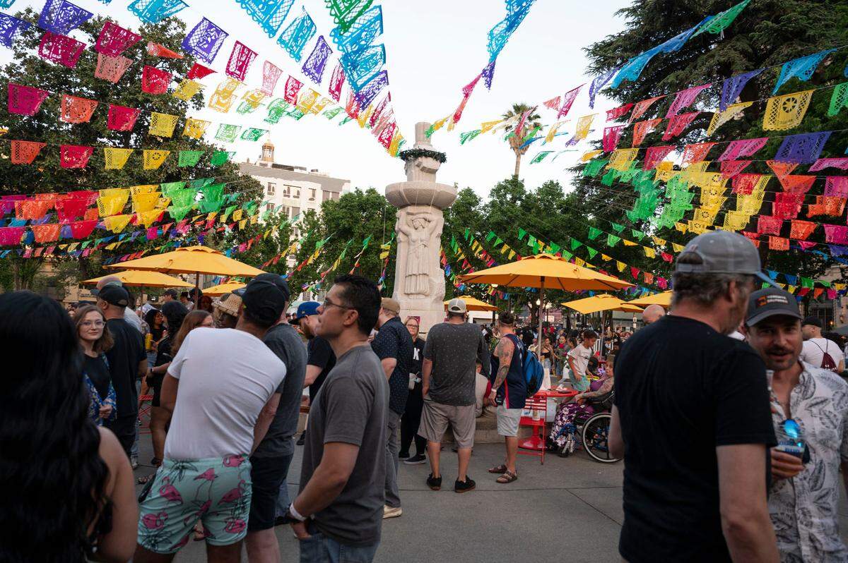 People celebrate the opening night of the Concert in the Park music festival series Friday, May 3, 2024, at Cesar Chavez Plaza. The concerts will continue every Friday night from 5 p.m. to 9 p.m. (except July 5) through the end of July.
