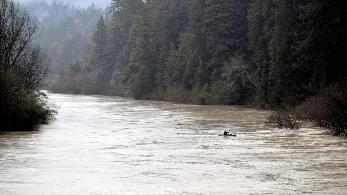 A man kayaks down the Russian River in Guerneville, Calif.
