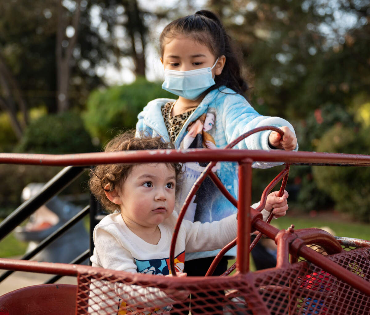 Ezra Molina drives a tractor under the watchful supervision of sister Scarlett at Fairytale Town on Thursday, Jan. 14.