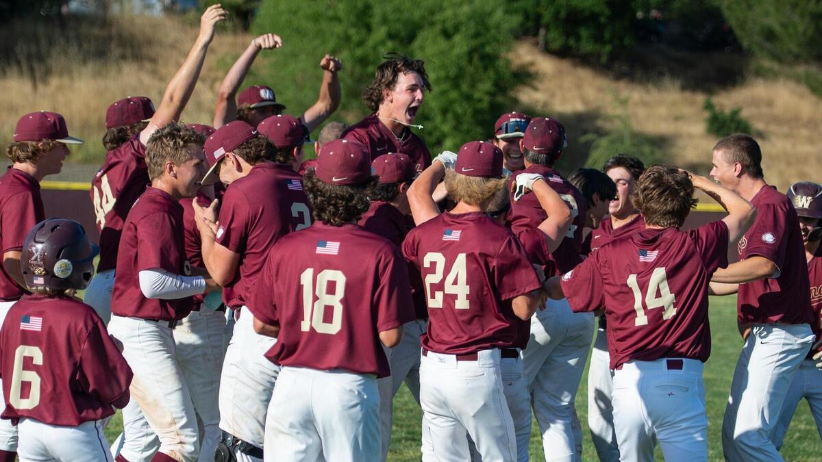 Whitney second baseman Jax Gimenez, center, jumps in the middle of the celebration after a game-winning hit by Nathan Erickson (11) during Game 1 of the CIF Sac-Joaquin Section Division I baseball semifinals against the St. Mary’s Rams in 2023 at Whitney High School in Rocklin.