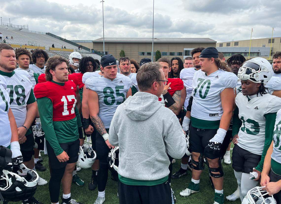 Quarterback Carson Conklin (17) and his Sacramento State teammates listen to offensive coordinator Eric Kiesau on Saturday following the team’s spring game.