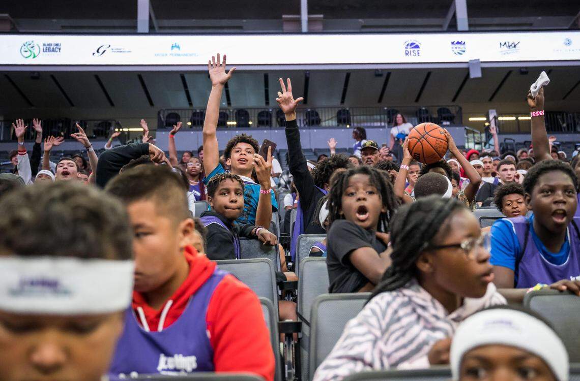 Children with the Kings and Queens Rise Co-Ed Youth Sports and Mentoring League raise their hands to speak with entertainer and businessman Curtis “50 Cent” Jackson during a Sacramento Kings event, presented with Jackson’s G-Unity Foundation, at Golden 1 Center on Saturday, June 10, 2023, to kick off the league’s sixth season in Sacramento.