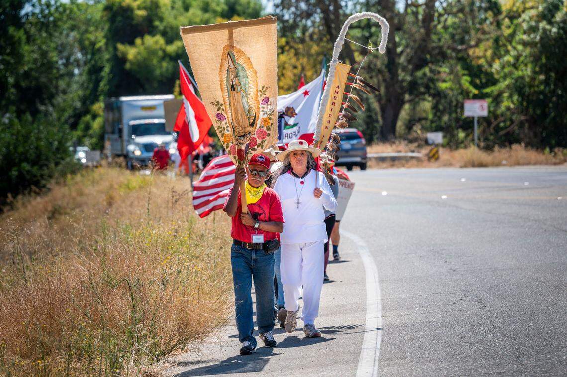 UFW president Teresa Romero, right, leads a march on Tuesday, Aug. 23, 2022, as they continue a 24-day, 335-mile march that will conclude today with a rally at the Capitol.