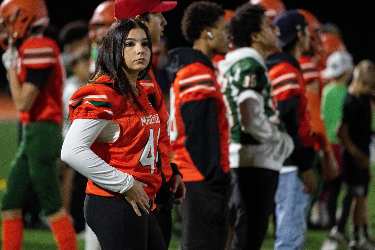 Alyssa Lauriano watches from the sidelines as Mesa Verde breaks in its brand-new football field Friday, Oct. 13, 2023, against Rio Linda.