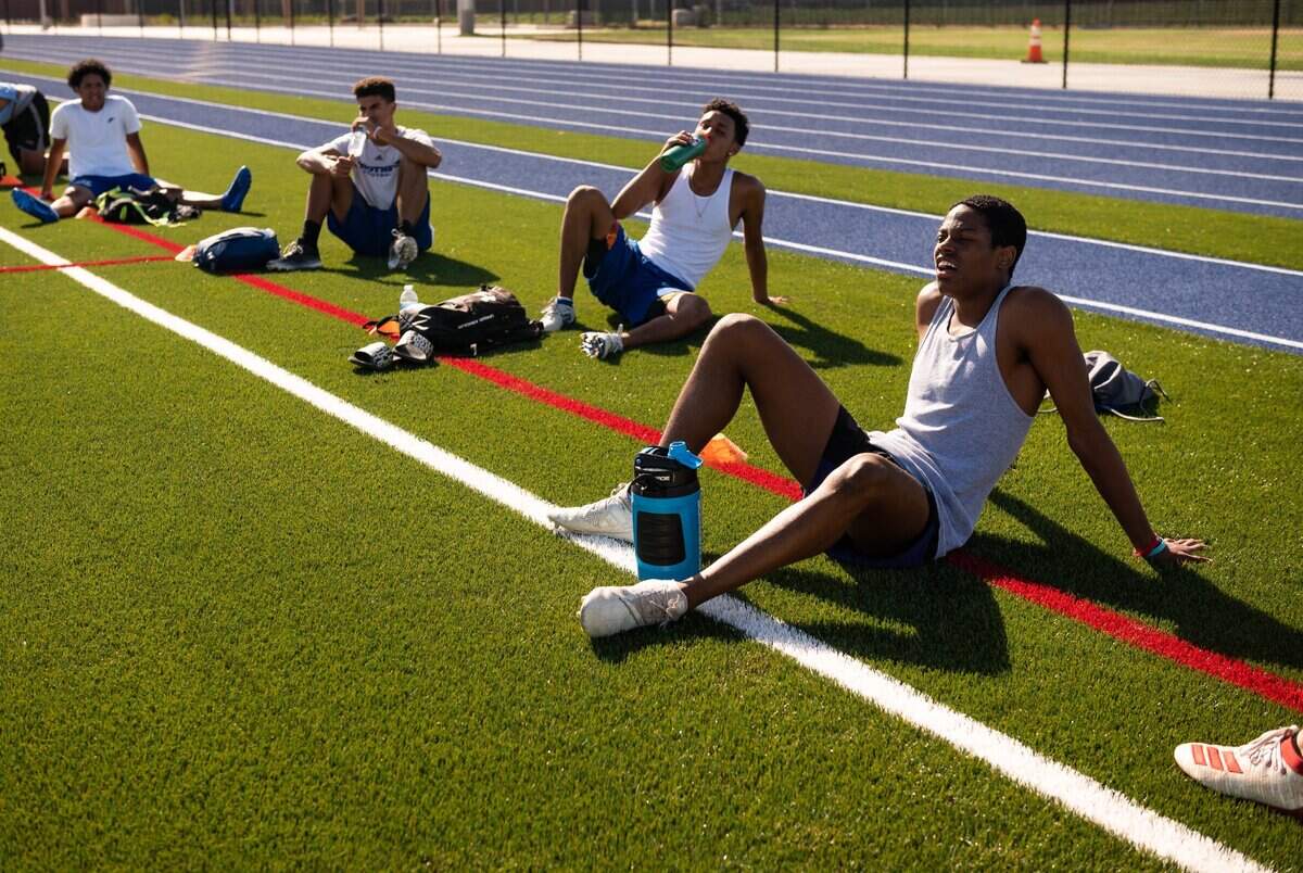 Christian Brothers High School football players, from right, Avante Lee, Zeke Jackson, Jared Wiley and Marcus Price take a much-appreciated hydration break during planned socially distanced summer conditioning drills without a football Thursday, June 18, 2020, on the Sacramento school’s new turf.