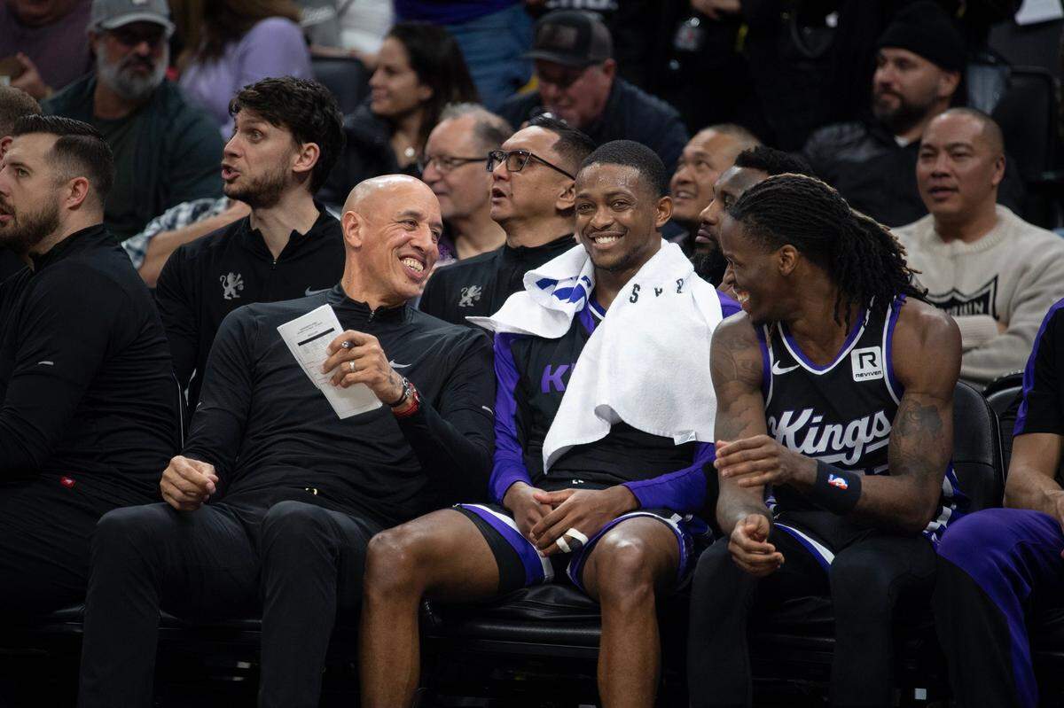Sacramento Kings assistant coach Doug Christie talks with guards De’Aaron Fox (5) and Keon Ellis (23) in the first half of the NBA game against the Detroit Pistons on Dec. 26 at Golden 1 Center.