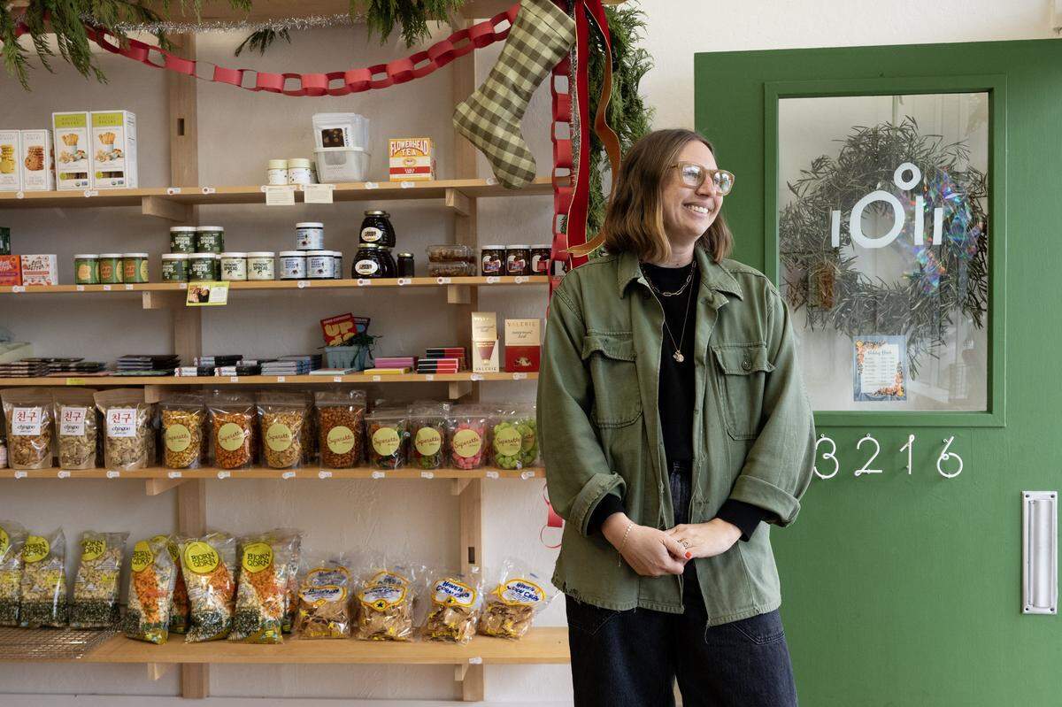 Owner Sophie Mosgrove stands in the entrance of Superette Market on Riverside Boulevard in Sacramento earlier this month. The small market serves gourmet goods with a focus on community.
