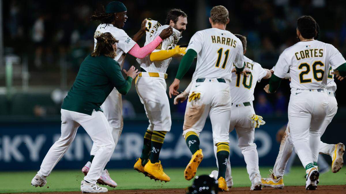 Sep 26, 2025; West Sacramento, California, USA; Athletics catcher Shea Langeliers (23) celebrates with teammates after hitting a walk-off RBI double during the ninth inning against the Kansas City Royals at Sutter Health Park. Mandatory Credit: Sergio Estrada-Imagn Images