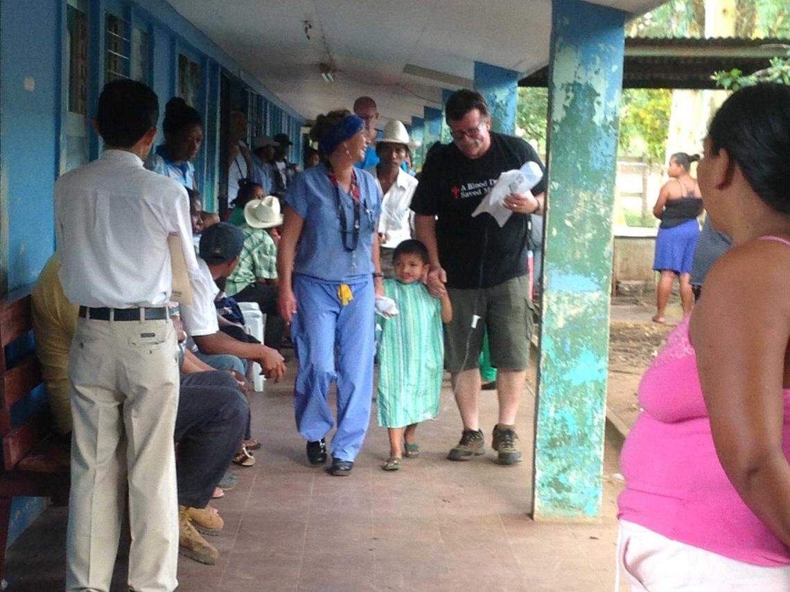Suzie Smith, center, and her husband, RJ, walk with a young patient who was treated in 2014 during one of Smith's many medical missions to Nicaragua. Smith, who was injured in Monday's medevac crash on Highway 50, died Friday from her injuries.