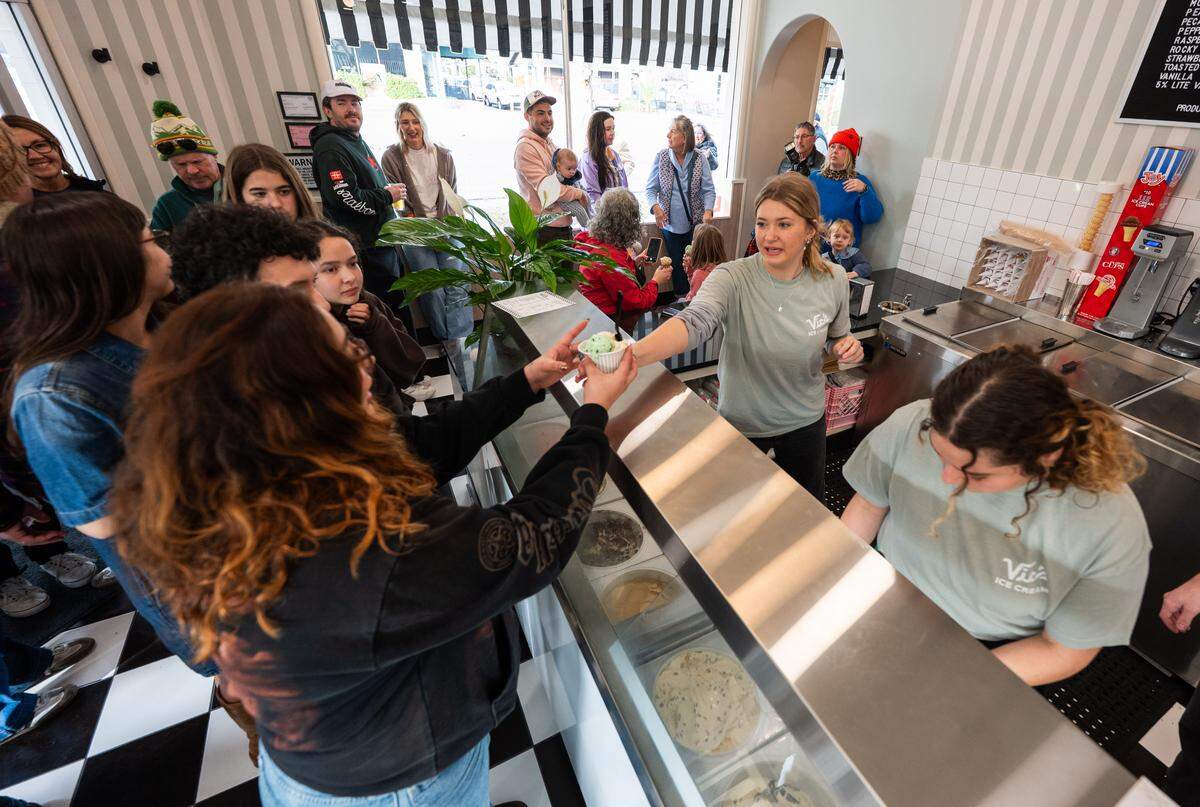 Lucy Moore serves a cup of ice cream at Vic’s Ice Cream in Sacramento during its reopening on Saturday.