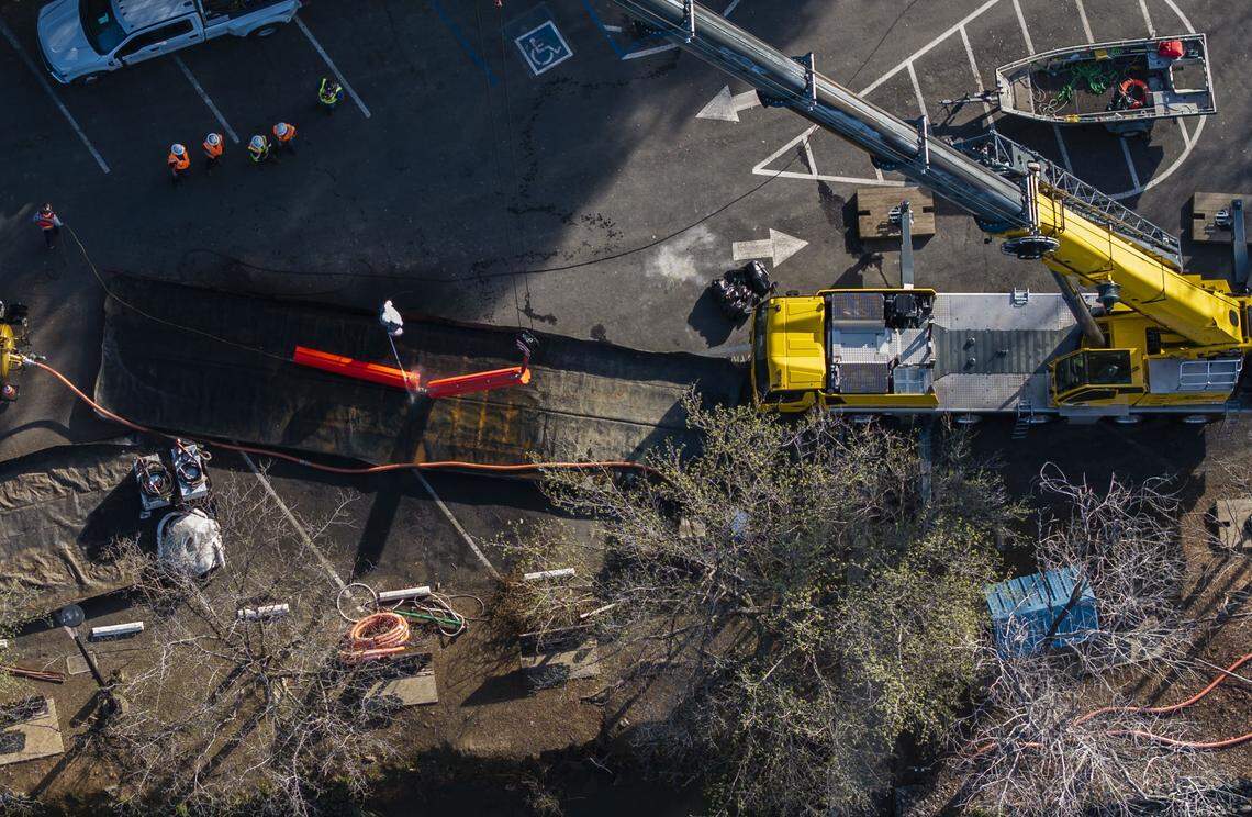 Crews work on clearing hard debris booms that blocked and trapped large logs and pieces of debris at Englebright Lake on Tuesday, March 3, 2026, following the large pipe rupture at the New Colgate Powerhouse on Feb. 13.