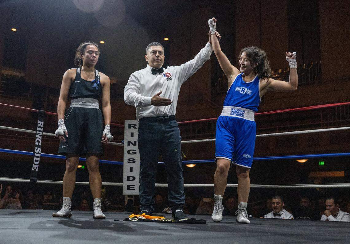 Aisya Hirzy of UC Davis celebrates her victory against Samantha Villa of the Air Force Academy during the Causeway Boxing Classic at Sacramento's Memorial Auditorium on Friday.